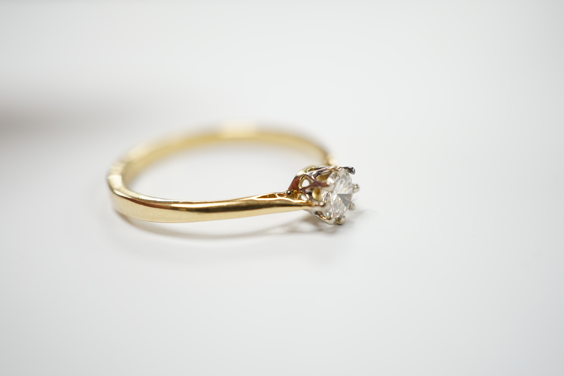 An 18ct and solitaire diamond set ring, size R, gross weight 2.8 grams.